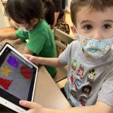 young child looking at his ipad screen