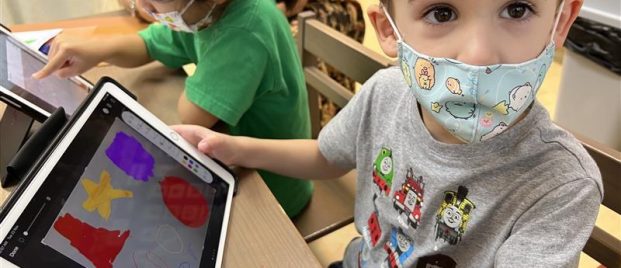 young child looking at his ipad screen