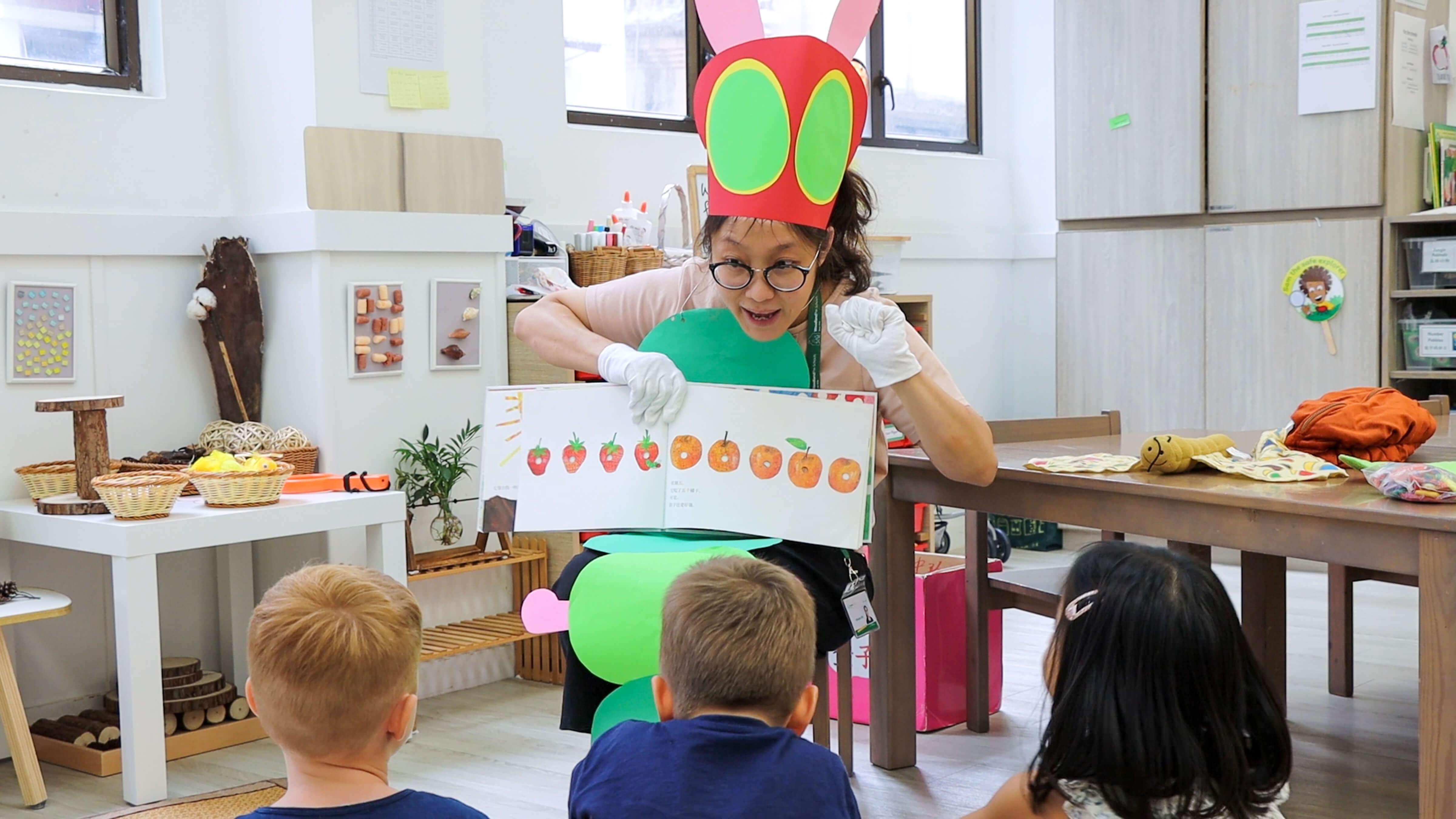 kindergarten teacher showing chinese characters to a class